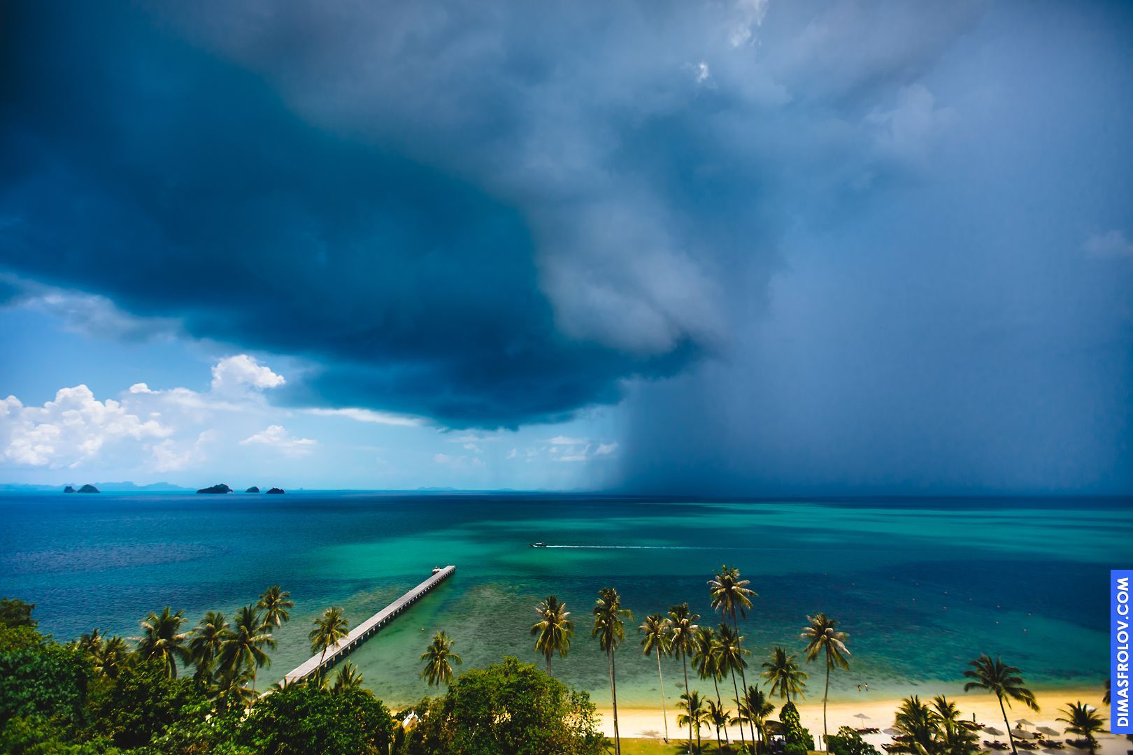 Dramatic coastal landscape with a long pier stretching out into a stormy sea under a dark, cloudy sky